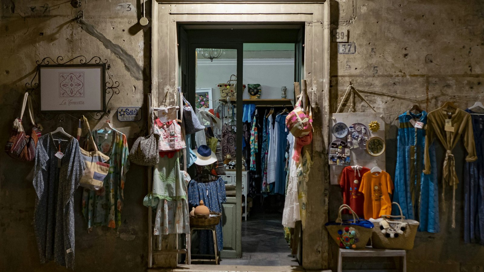 assorted clothes hanging in front of store